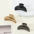 Three matte mini claw clips in black, beige, and grey on a clean white display stand - Classic Half-moon (287)