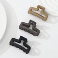 Detailed macro of three matte geometric hair claws in beige, brown, and black colors - Morandi Rectangle (405)