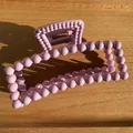 Matte taro purple hair claw clip with ball texture and rectangular frame on wood surface - Purplish Red