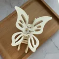 Detail of cream hollow butterfly hair claw clip with matte finish and metal spring - Off-white