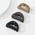 Close-up of three matte hair claws in neutral black, coffee, and khaki earth tones - Neutral D-shape (403)