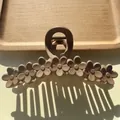 Macro shot of matte beige flower hair claw clip with detailed floral relief pattern - Light Coffee