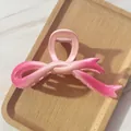 Macro view of gradient pink ribbon bow hair claw clip showing glossy resin texture - Pink Gradient