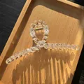 Close-up of large transparent bubble bead shark clip on wooden tray with natural sunlight - Clear White