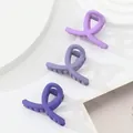 Detailed view of three matte purple gradient mini hair claws on a minimalist stone display - Purple Gradient (232C)