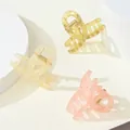 Close-up of matte jelly texture resin hair claws in yellow, beige and pink tones - Crossed Arc Hollow Style / Bright Matte Colors (307A)