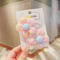 Detail of two pink mesh flower hair clips with sequins on a branded paper card - Pink 2