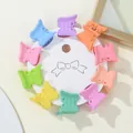 Detailed view of ten colorful mini butterfly hair clips on a white round card - Butterfly