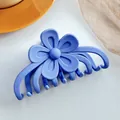 Detail of matte blue flower hair claw clip with interlocking teeth on grey background - Haze Blue