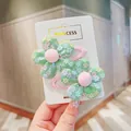 Detail of green mesh flower hair clips with colorful sequins and pink ribbon lining - Dark Green