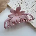 Detail of pink matte flower hair claw clip with smooth texture on a stone background - Frosted 3D Flower / Warm Pale Pink