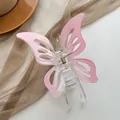 Macro detail of hollow pink butterfly hair claw with transparent body and gold spring - Pink