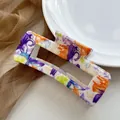 Detail of square hair claw clip with colorful floral water transfer print design - Colorful Morning Glory