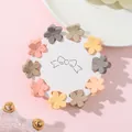 Detailed macro of colorful matte floral hair mini claws arranged on a display card - Five-Petal Flower Style (G)