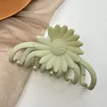 Close-up of matte light green daisy hair claw clip on white background with mesh - Light Green