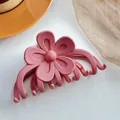 Detailed macro view of a pink matte flower claw clip with a refined frosted finish - Pink