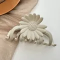 Detail of cream daisy hair claw clip with matte finish and secure grip teeth - Cream Color