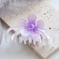 Detailed view of large purple flower hair claw clip with gradient petals on stone surface - White Purple