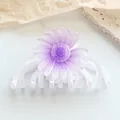 Detail of lavender daisy hair claw clip with glitter finish and translucent petals - White Purple