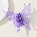 Close-up of a purple translucent butterfly hair claw clip with detailed wing patterns - Purple