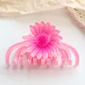 Detail of pink translucent daisy hair claw clip with smooth resin finish and round teeth - Pink