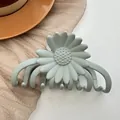 Detail of matte mint green daisy hair claw clip on soft fabric and white surface - Mint Green