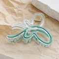 Detail of transparent butterfly hair claw with green and white wave pattern and gold spring - Dark Coffee
