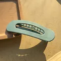 Detail of Morandi green matte hair claw clip on wooden tray with strong side lighting - Light Blue