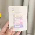 Detailed view of four 4cm wave-shaped colorful hair clips in pastel cream and pink - Wave