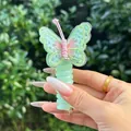 Detail of mint green embroidered butterfly hair tie with spiral band held by hand - Bowknot Style / Off White
