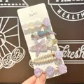 Detalle de 5 horquillas marinas con perlas y conchas de reflejos brillantes - Morado