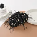Elegant black cream polka dot bow hair claw clip with feathers on leather surface - White Polka Dot Style With Feathers