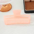 Translucent peach pink rectangular hollow hair claw clip with a matte finish and metal spring - Pink