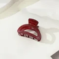 Detailed view of the dark red glossy shark hair claw clip with strong metal spring - Small Semicircle Style / Burgundy