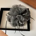 Detailed shot of grey mesh scrunchie with faux pearls and ribbons on display tray - Dark Gray