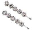 Dettaglio di fermagli per capelli argentati con motivi floreali di strass scintillanti - Bianco