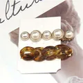 Detail view of pearl metal hairpin and amber acrylic chain clip on display card - Pearl And Amber Chain