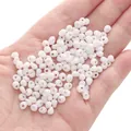 Hand holding white 5x5mm teardrop glass seed beads for DIY jewelry making - 10g/Pack (Approx. 100 Beads) / White