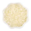 Creamy white cat eye glass seed beads in a white ceramic dish for DIY jewelry making - 2.5mm, Hole approx 1mm, 450g/Pack, Approx 33000 Pieces / Beige