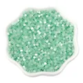 Mint green cat eye glass seed beads in a white floral dish for DIY jewelry making - 2.5mm, Hole approx 1mm, 450g/Pack, Approx 33000 Pieces / Light Green