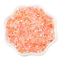 Mix of orange and pink cat eye glass beads for DIY jewelry making in a white ceramic bowl - 2.5mm, Hole approx 1mm, 450g/Pack, Approx 33000 Pieces / Orange Mix