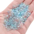 Light blue iridescent glass cube beads held in hand for handmade jewelry DIY - 1x3mm (1g/Pack, Approx. 50 Pcs) / Flat Square Style (BBA118) / Blue