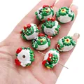 Handmade glass snowman bead for DIY Christmas jewelry crafts shown on palm for size - Green Snowman (#39)