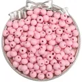 Pink matte wooden beads in a metal dish for DIY jewelry making and crafts - Spring Light Pink