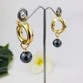 18K gold plated hoop earrings with iridescent black pearl drops on a display stand - Dark Aurora Pearl Style (HWX958-1)