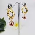 Vintage 18K gold plated hoop earrings with natural shell pearl drops on a display stand - Lotus Pink Pearl Style (HWX958-2)