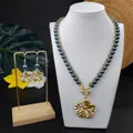 Hawaiian plumeria jewelry set with gold necklace and purple pearl earrings on display - Iridescent Dark Purple (HWNX9344-1)