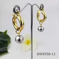 Detail of 18K gold hoop earrings with silver-grey shell pearls on a metal stand - Silver Gray Pearl Style (HWX958-11)