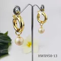 Detail of 18K gold chunky hoops with natural shell pearl pendants on a jewelry stand - Beige Pearl Style (HWX958-13)