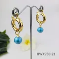 Detail of 18K gold plated hoop earrings featuring a lustrous light blue pearl pendant - Pale Blue Pearl Style (HWX958-21)